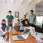 Group of young professionals engaged in a collaborative meeting in a modern office setting.