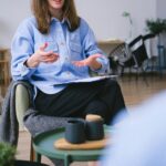 A therapist consults with a client in a contemporary office, focusing on mental health.