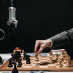 A robotic arm plays chess against a human, symbolizing AI innovation and strategy.